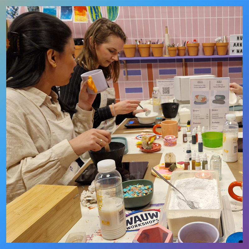 Deelnemers mengen grondstoffen voor terrazzo workshop items gieten